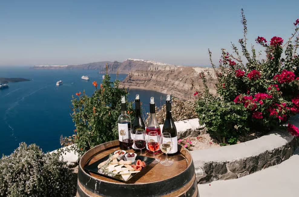 Overviewing the cliffs of Santorini, experience Santorini wine tour in a cosy and intimate atmosphere