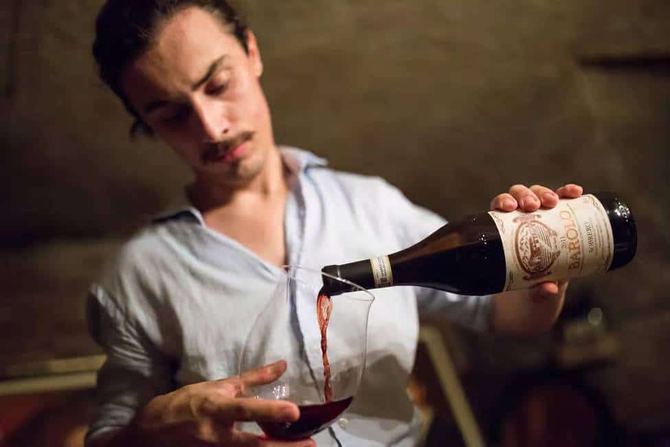 winery visit and sommelier pourring wine in Castiglione Falletto Barolo Chinato Olive Oil Tasting tour